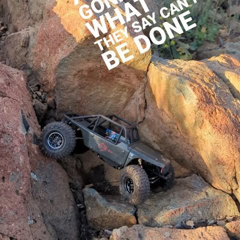 RC crawler climbing a steep rock face